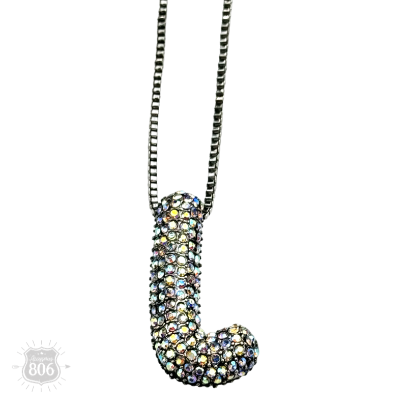 Rhinestone letter pendant on silver necklace