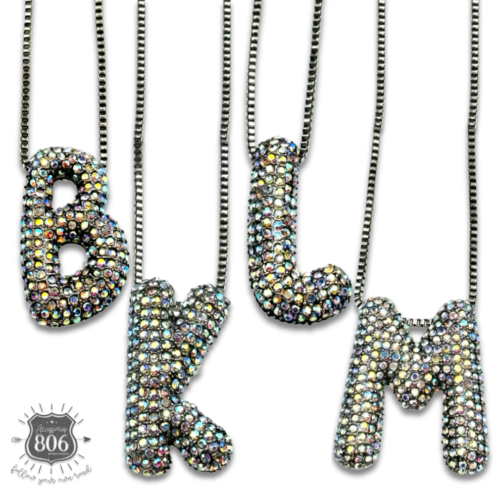Rhinestone letter pendant on silver necklace